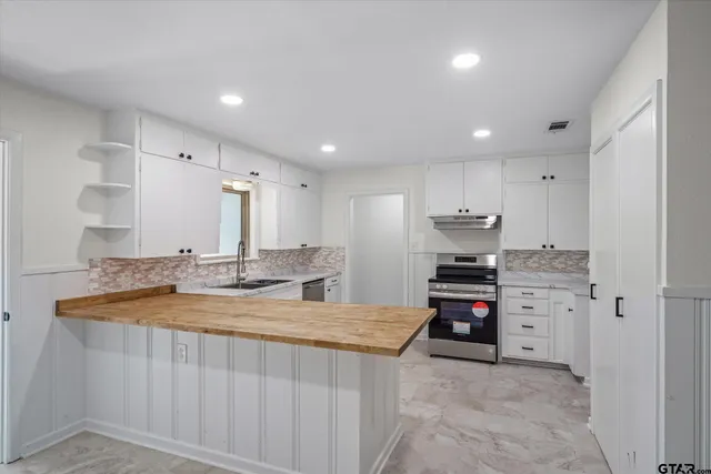a kitchen with stainless steel appliances granite countertop a sink and cabinets