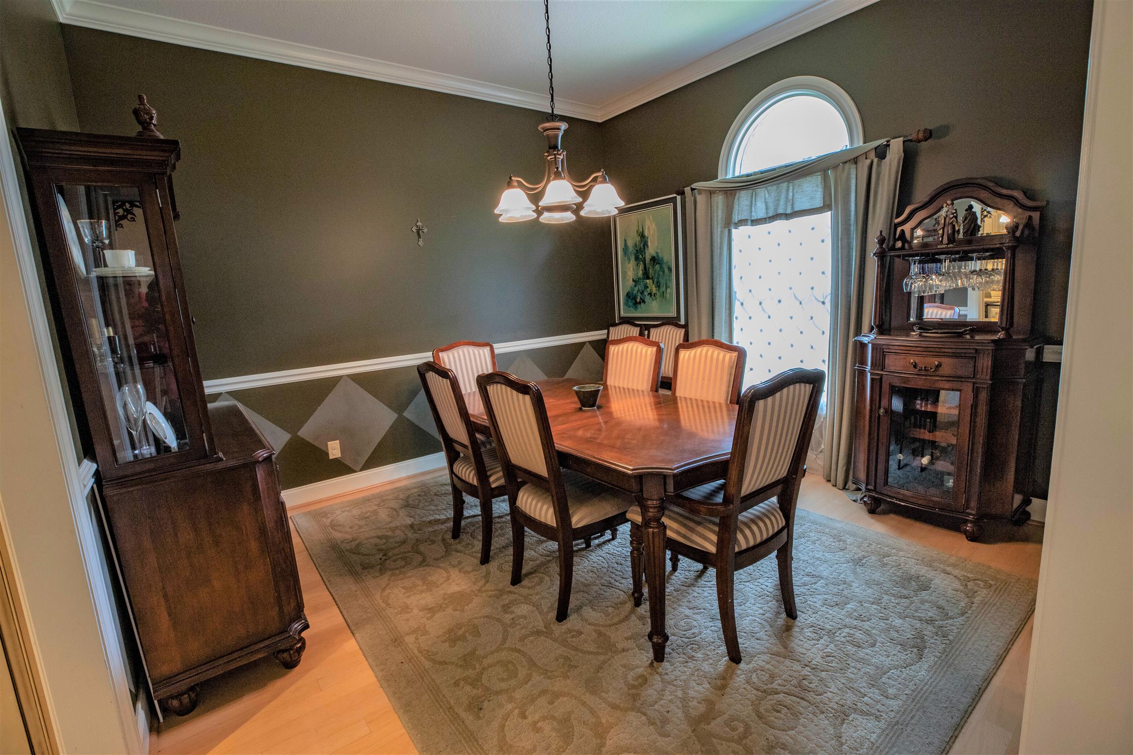 210 Airport Road Waverly, TN 37185 - Photo 15 of 30 The formal dining room has a hardwood floor, arched window and chair rail trim.