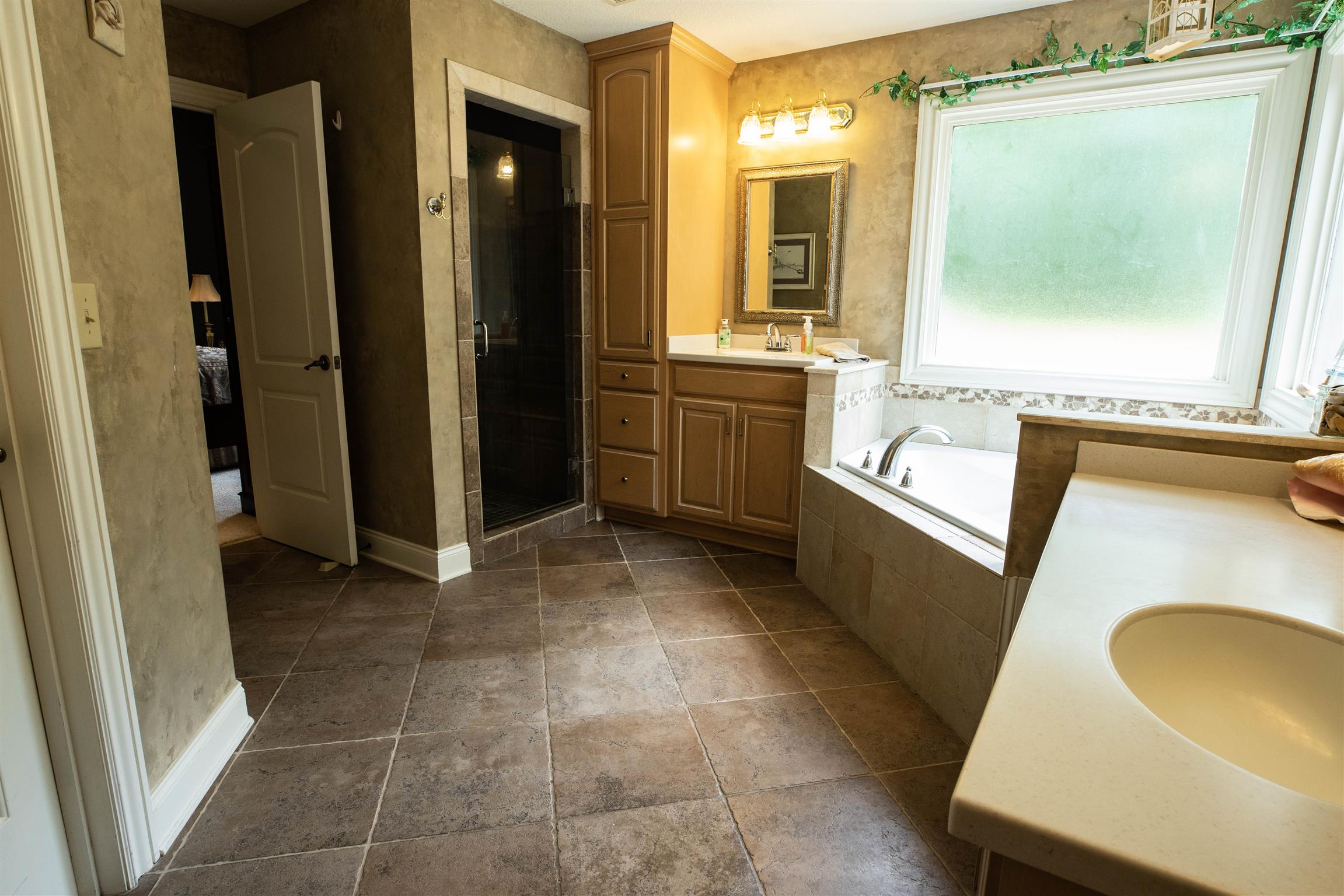 210 Airport Road Waverly, TN 37185 - Photo 18 of 30 Start each day happy in this cheery tiled master bath, complete with Jacuzzi tub and separate shower.