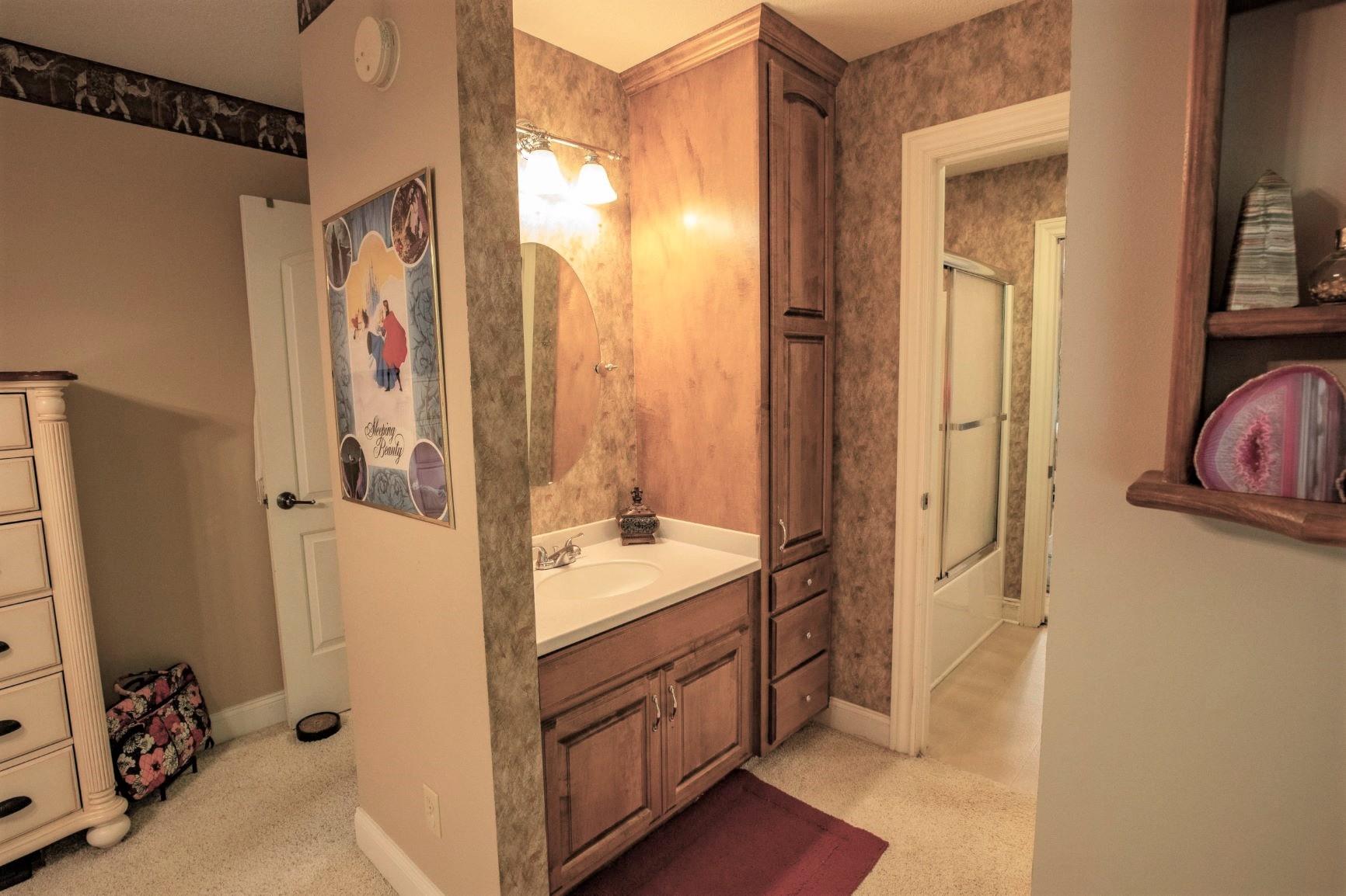 210 Airport Road Waverly, TN 37185 - Photo 21 of 30 Each of the two bedrooms has a separate vanity and share a full bath with shower.