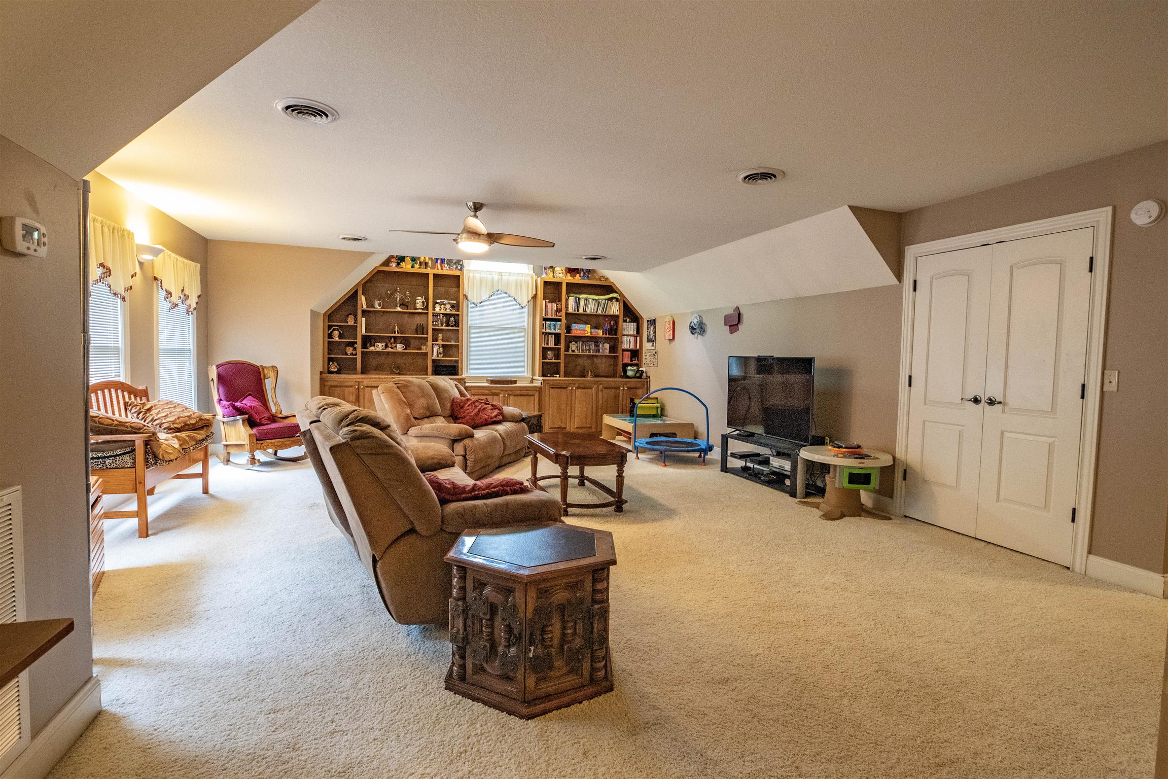 210 Airport Road Waverly, TN 37185 - Photo 25 of 30 Built-in bookshelves and cabinets are a focal point in the large rec room/den upstairs. Additional storage space is an added bonus!
