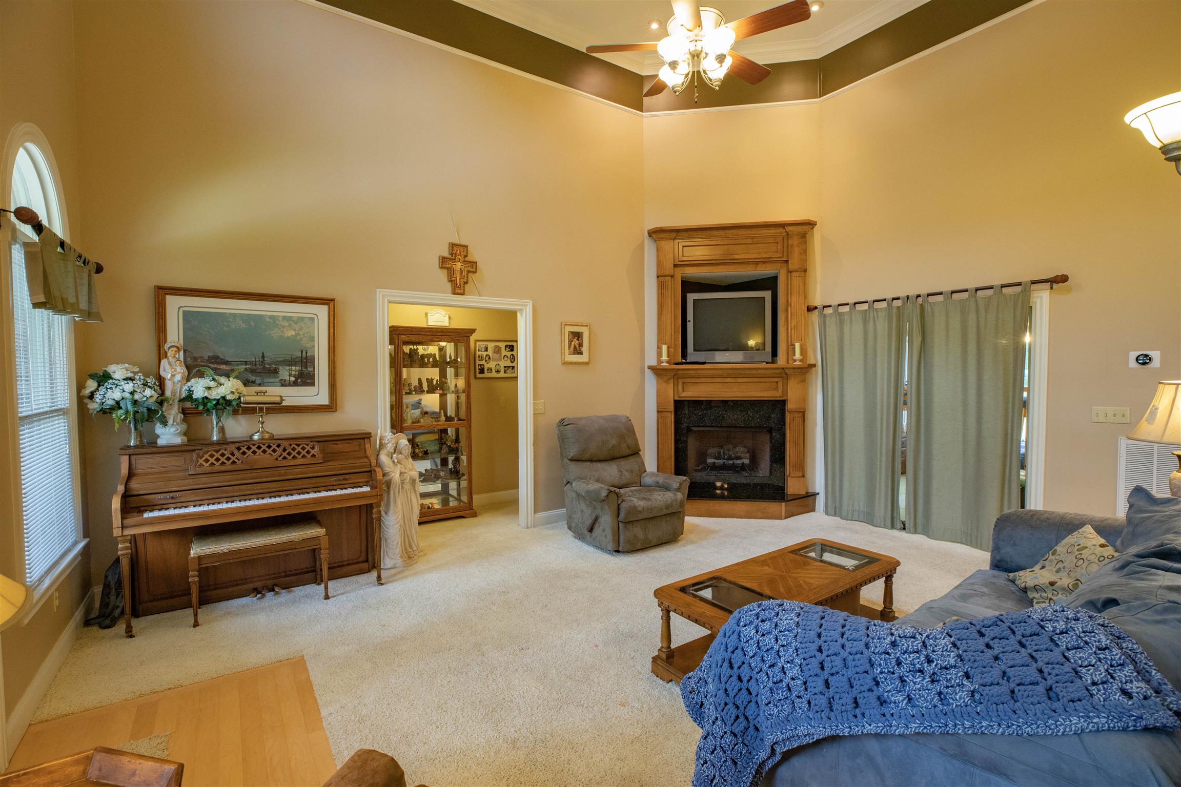 210 Airport Road Waverly, TN 37185 - Photo 8 of 30 The spacious living room includes a cathedral ceiling, propane fireplace, and a beautiful double mantle. The sliding door leads to the sunroom.
