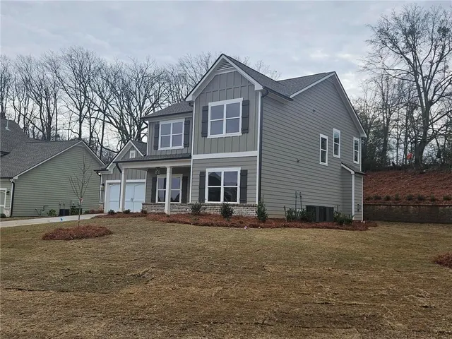 a front view of a house with a yard