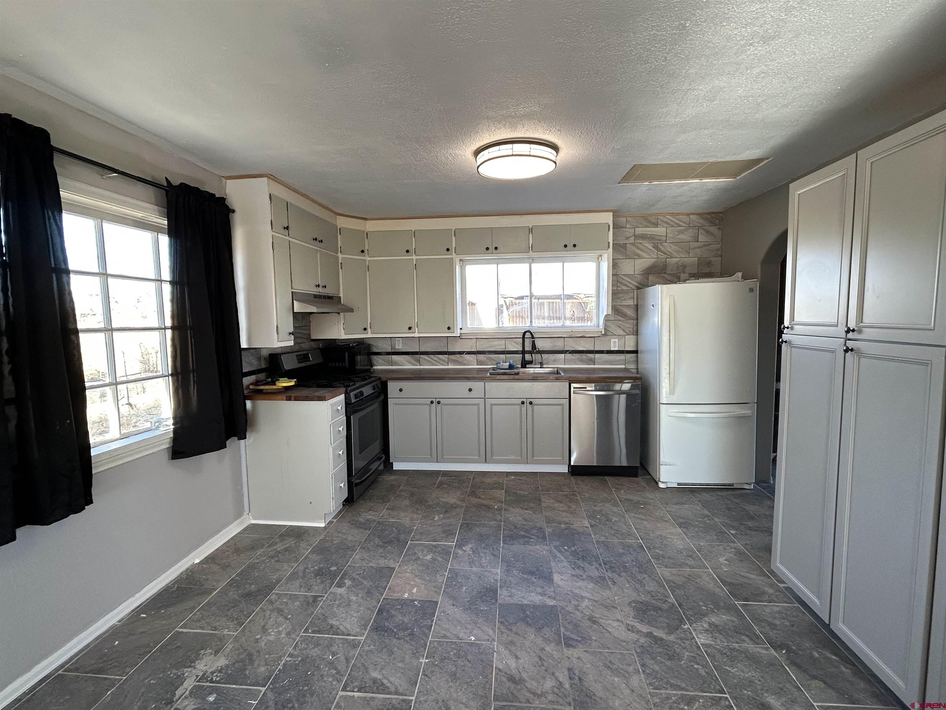 27643 BB Road Nucla, CO 81424 - Photo 3 of 21 a kitchen with stainless steel appliances granite countertop a refrigerator sink and window