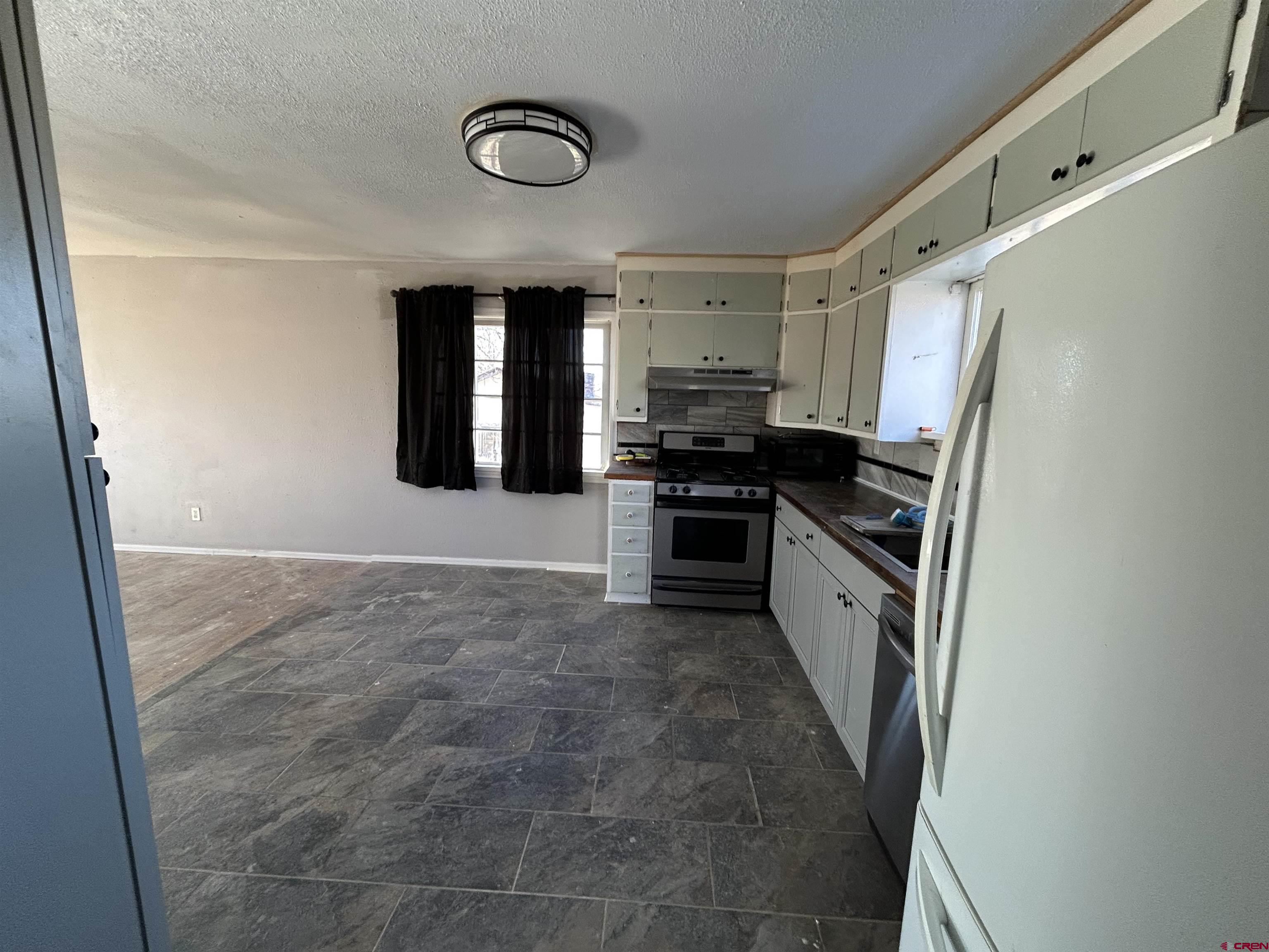 27643 BB Road Nucla, CO 81424 - Photo 4 of 21 a kitchen with stainless steel appliances a refrigerator and a stove top oven