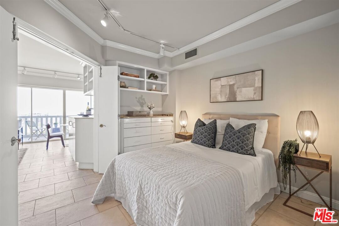 999 North Doheny Drive, Unit 806 West Hollywood, CA 90069 - Photo 5 of 11 a bedroom with a bed and a view of bathroom