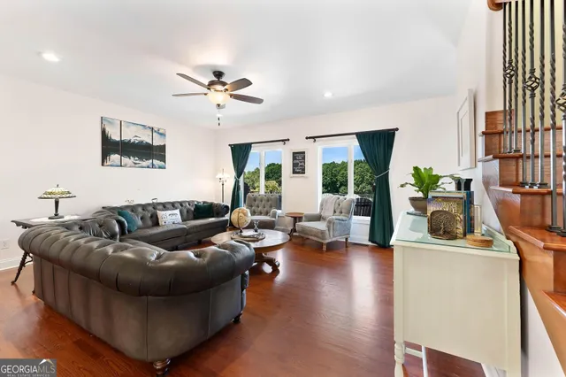 a kitchen with kitchen island stainless steel appliances a sink cabinets and wooden floor