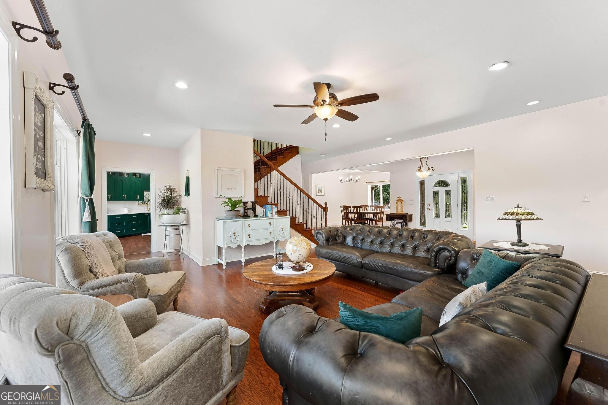 366 Curt Bailey Road Hartwell, GA 30643 - Photo 14 of 83 a living room with furniture a rug and a chandelier
