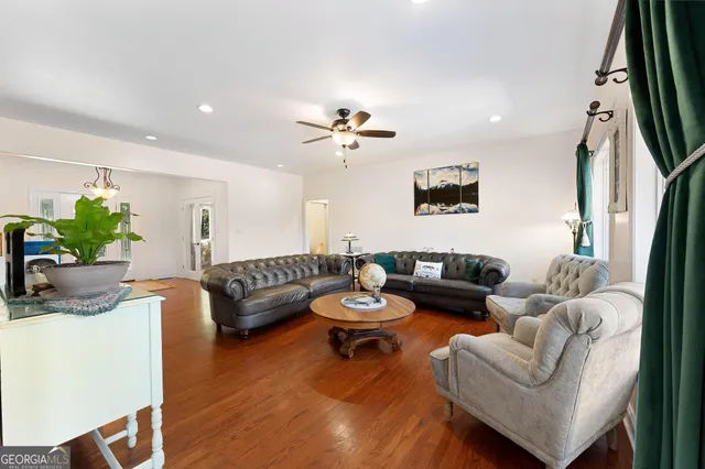 a large kitchen with kitchen island a large counter top space a sink stainless steel appliances and cabinets