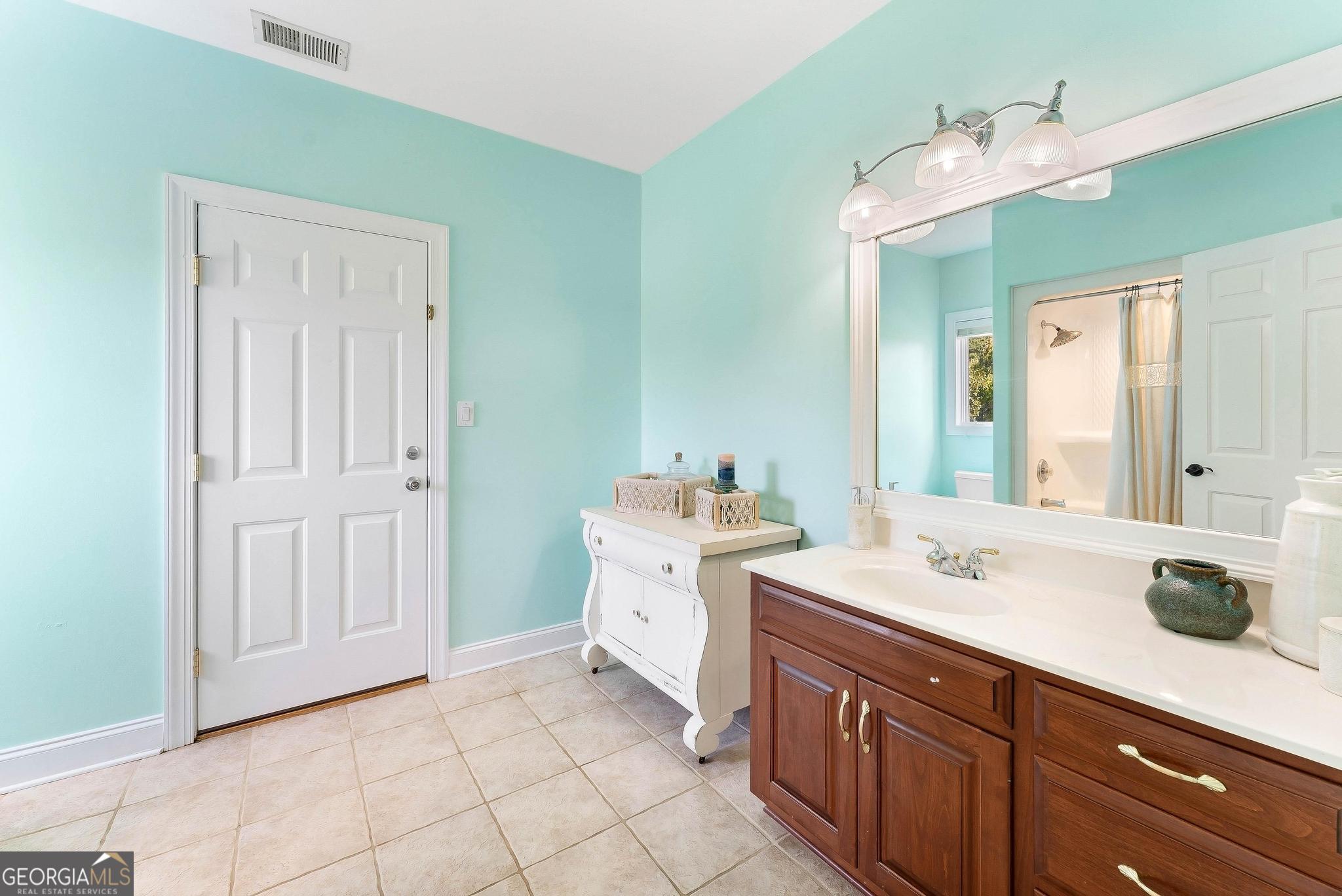 366 Curt Bailey Road Hartwell, GA 30643 - Photo 60 of 83 a spacious bathroom with a double vanity sink and a mirror