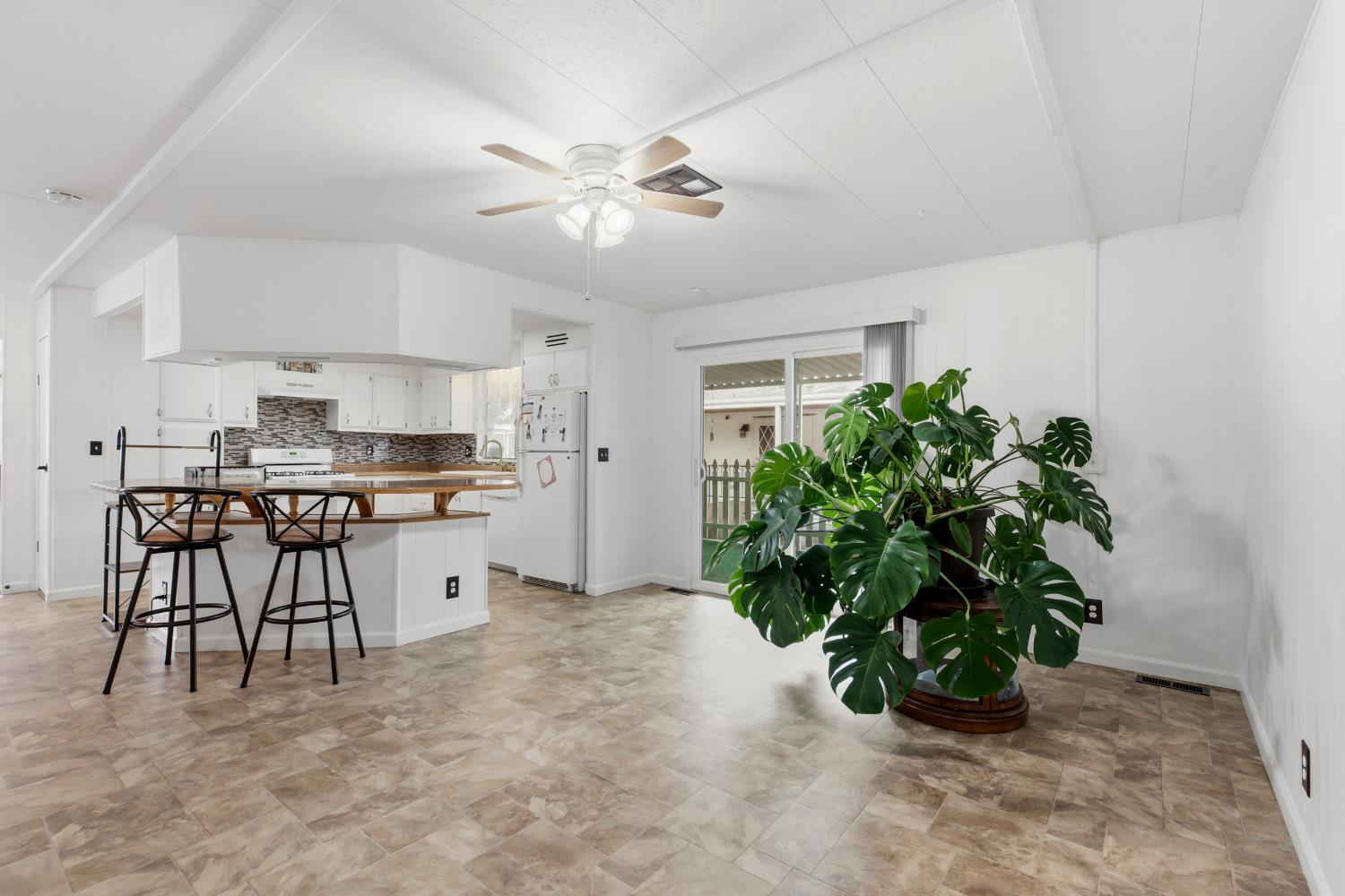 3921 Moana Way Modesto, CA 95355 - Photo 11 of 34 a kitchen with stainless steel appliances a table and chairs in it