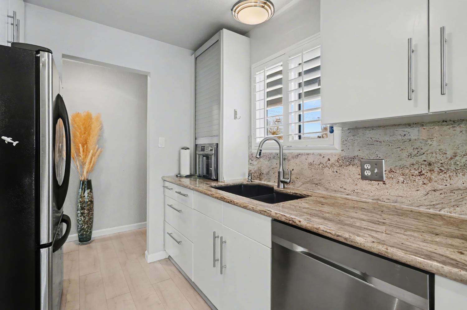 10500 Spaulding Way Rancho Cordova, CA 95670 - Photo 11 of 39 a kitchen with stainless steel appliances granite countertop a sink stove and refrigerator