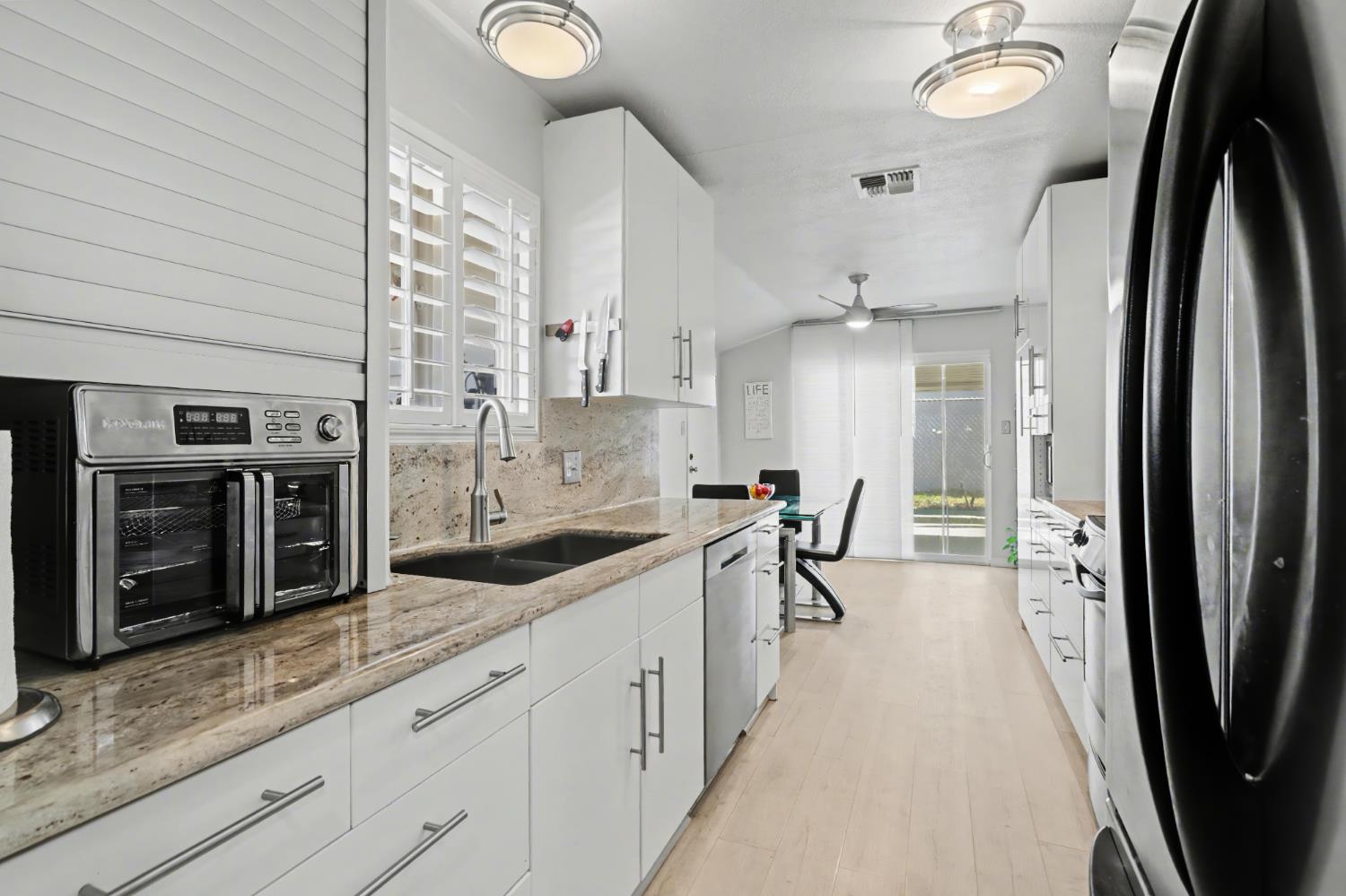 10500 Spaulding Way Rancho Cordova, CA 95670 - Photo 12 of 39 a kitchen with stainless steel appliances granite countertop a refrigerator and a sink