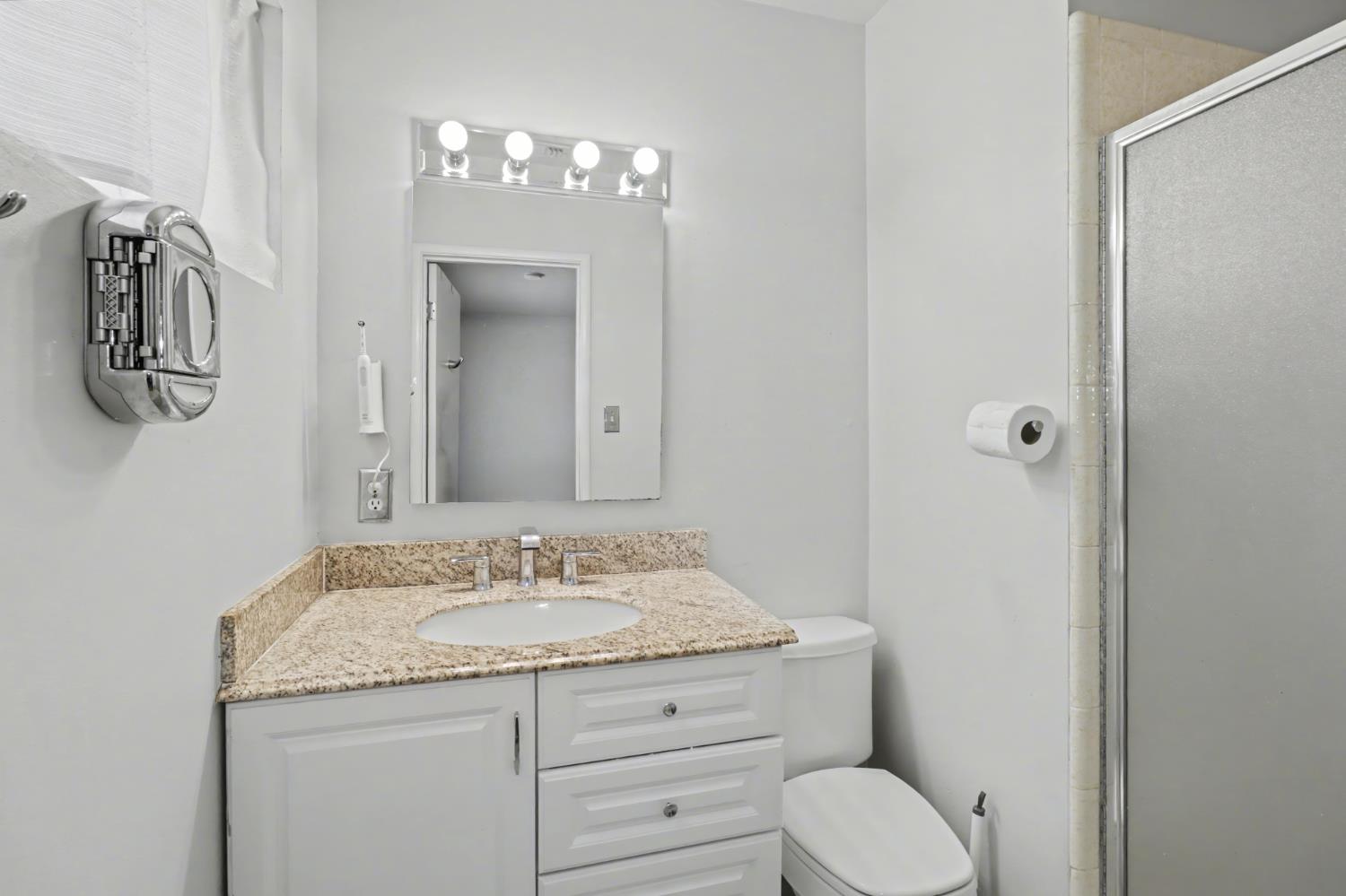 10500 Spaulding Way Rancho Cordova, CA 95670 - Photo 18 of 39 a bathroom with a granite countertop sink toilet and shower