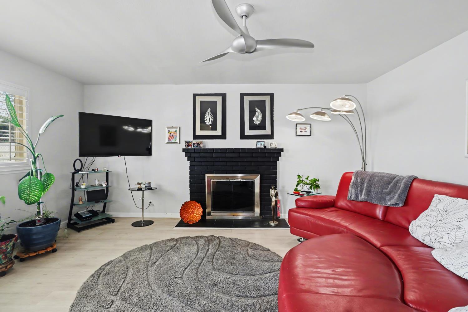 10500 Spaulding Way Rancho Cordova, CA 95670 - Photo 4 of 39 a living room with furniture a flat screen tv and a fireplace