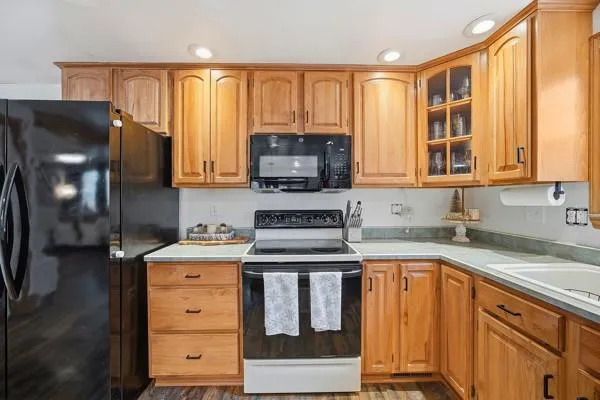 a kitchen with stainless steel appliances granite countertop a stove a sink and a microwave