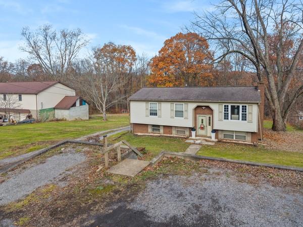 890 Grandview Road Ellwood City, PA 16117 - Photo 2 of 33 a view of a house with a big yard and large trees