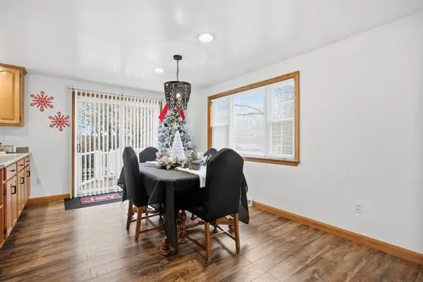 a view of a dining room with furniture window and wooden floor
