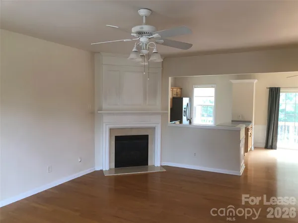 a view of a livingroom with a fireplace and window