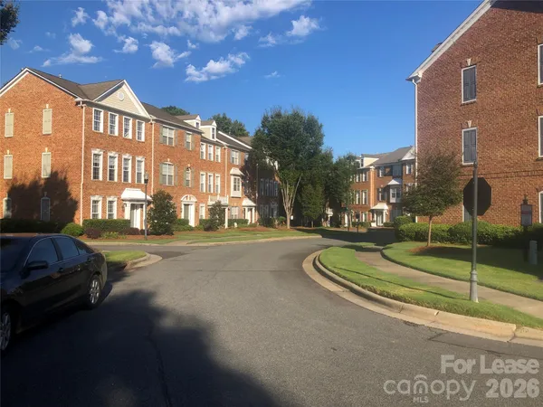 a view of a street with a building in the background