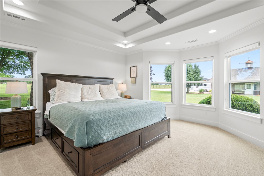 16556 East Hewitt Springs Road Springdale, AR 72764 - Photo 25 of 60 Bedroom featuring a tray ceiling with recessed lighting and a ceiling fan