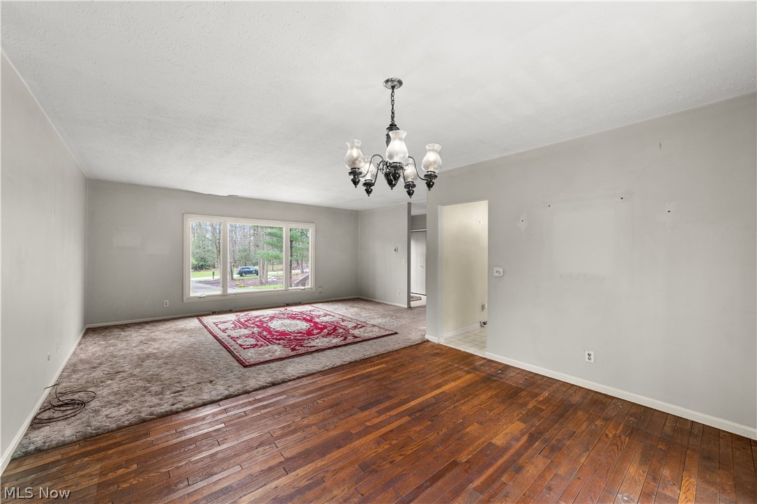 18763 Sharon Road Chagrin Falls, OH 44023 - Photo 18 of 37 Unfurnished room featuring hardwood / wood-style floors and a chandelier