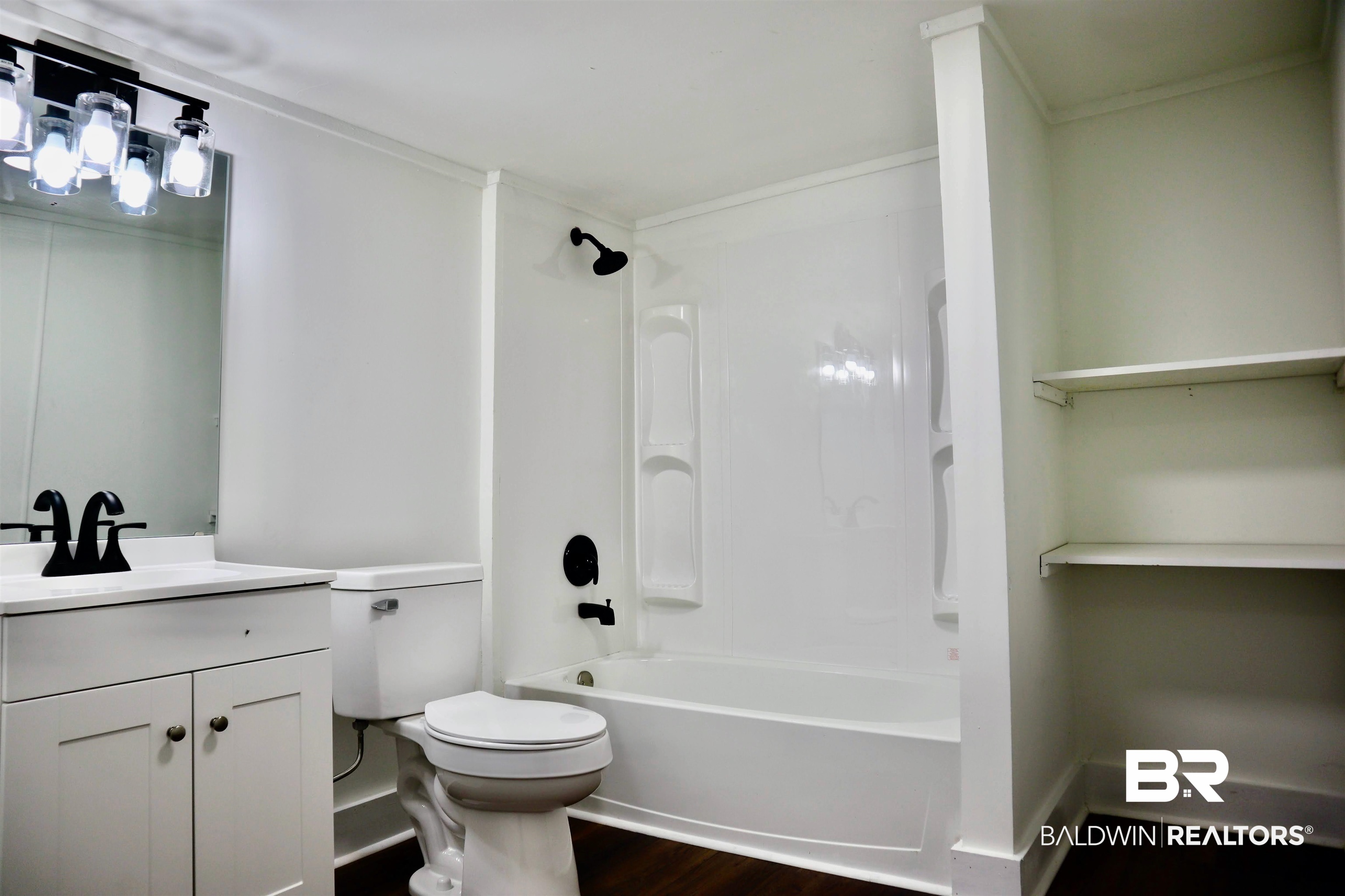 1009 Baltimore Street Mobile, AL 36605 - Photo 15 of 17 Bathroom featuring vanity, wood finished floors, shower / bath combination, and crown molding