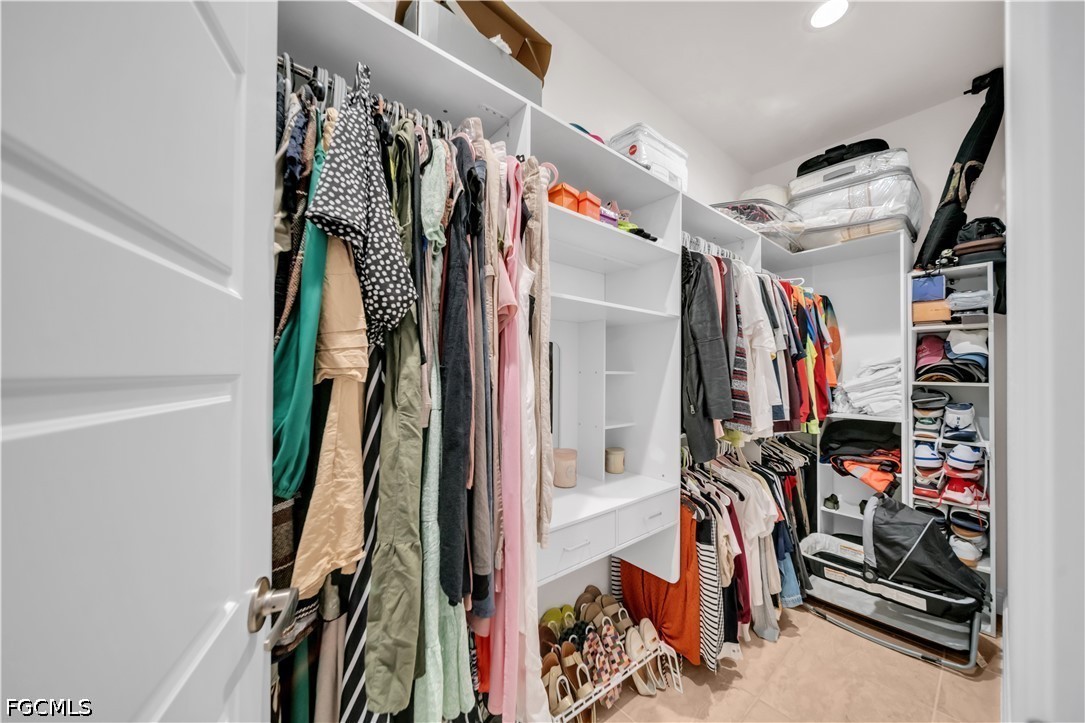 384 Neighborly Road LaBelle, FL 33935 - Photo 25 of 45 a view of walk in closet with clothes