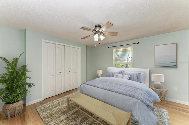 a bedroom with a large bed and a chandelier