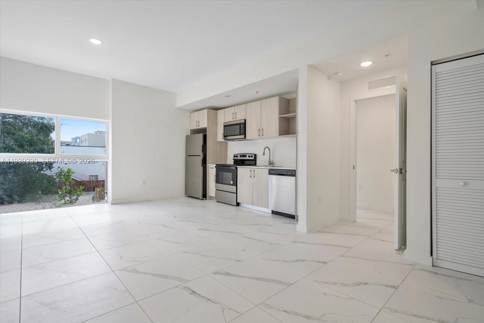 420 Southwest 7th Avenue, Unit 202 Miami, FL 33130 - Photo 3 of 19 a view of kitchen with refrigerator and window