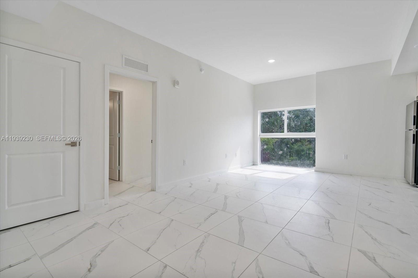 420 Southwest 7th Avenue, Unit 202 Miami, FL 33130 - Photo 7 of 19 a view of an empty room with a window