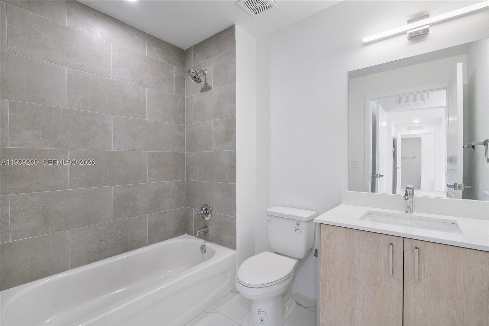 420 Southwest 7th Avenue, Unit 202 Miami, FL 33130 - Photo 8 of 19 a bathroom with a sink a toilet and bathtub