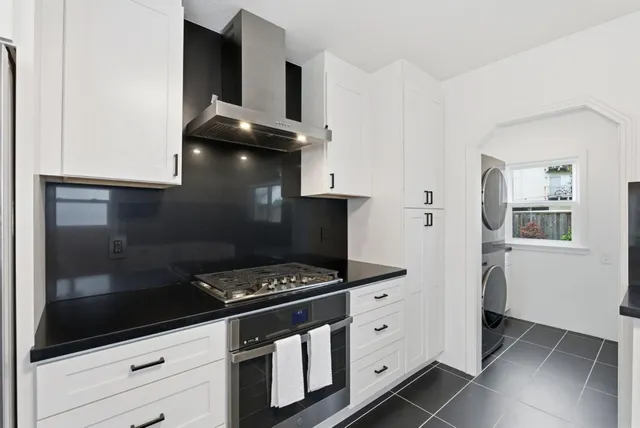 a kitchen with granite countertop a stove and a refrigerator