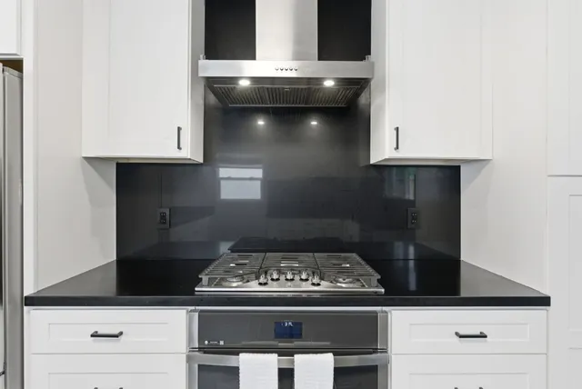 a stove top oven sitting inside of a kitchen