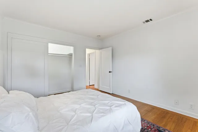 a bedroom with a bed and a wall painting