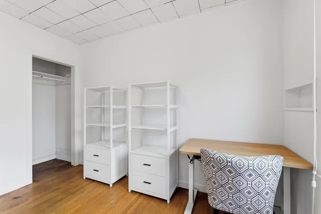 a view of bedroom with cabinet and wooden floor