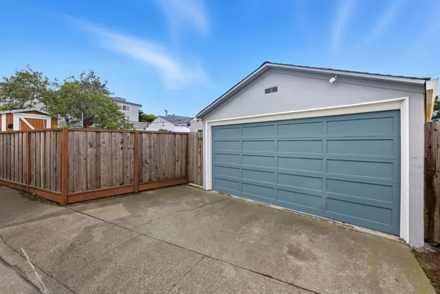 a view of backyard with cabin and wooden fence