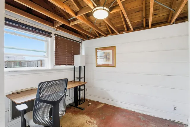 a view of a room with workspace and windows