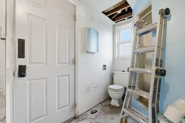 a bathroom with a toilet and a sink