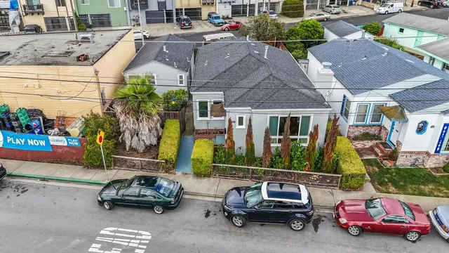 an aerial view of residential houses with outdoor space