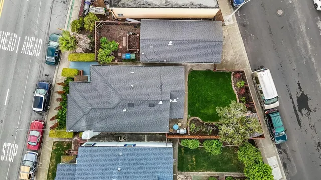 an aerial view of a house with a yard