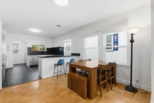 a view of a dining room with furniture and wooden floor