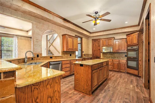 a kitchen with stainless steel appliances granite countertop a sink stove and refrigerator