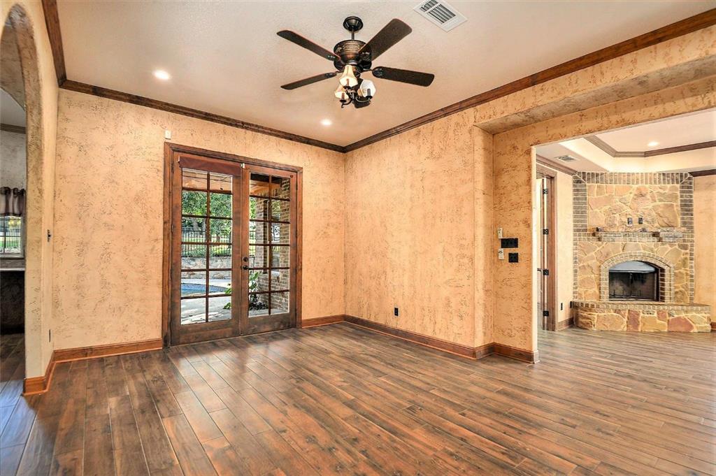 112 Bonita Drive Springtown, TX 76082 - Photo 13 of 39 wooden floor in an empty room with a fireplace