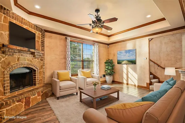 a living room with furniture a fireplace and a flat screen tv