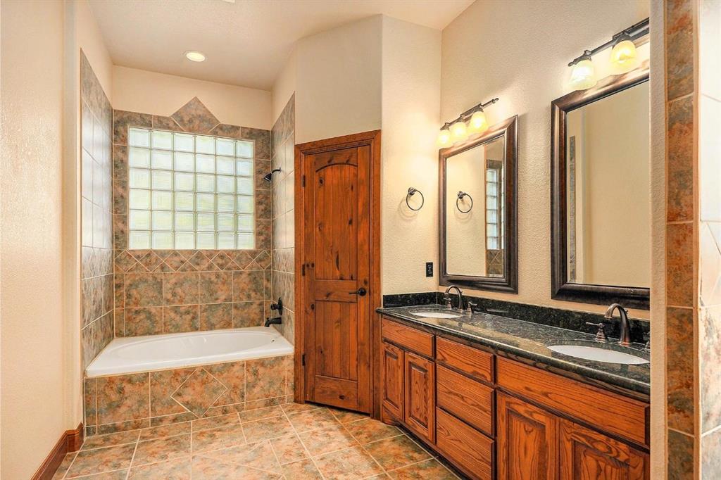 112 Bonita Drive Springtown, TX 76082 - Photo 21 of 39 a bathroom with a tub a sink and a shower