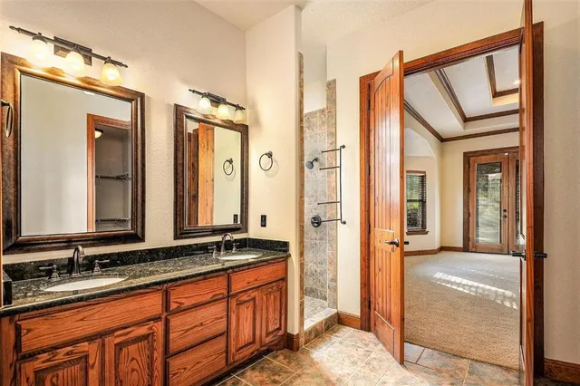 a bathroom with a double vanity sink and a mirror