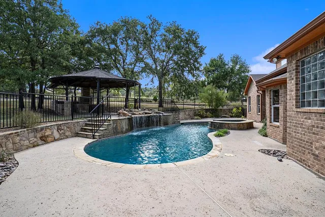 swimming pool view with a seating space