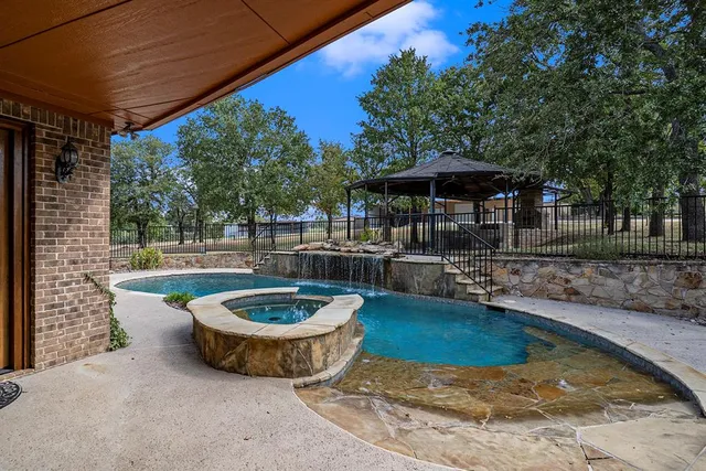 a view of a swimming pool with a patio