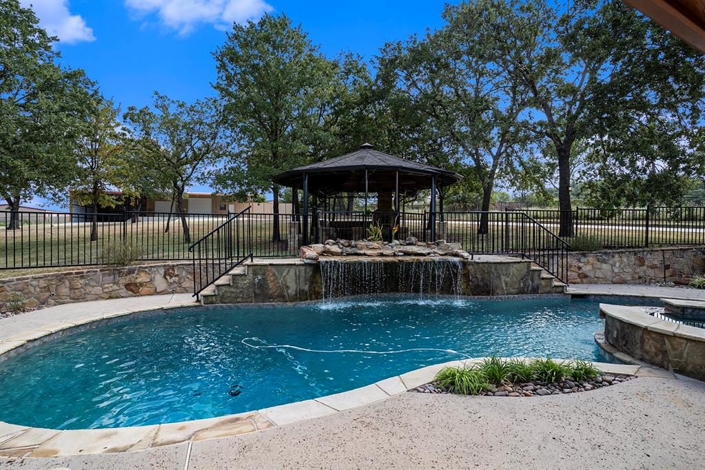 112 Bonita Drive Springtown, TX 76082 - Photo 4 of 39 a view of a swimming pool with a patio